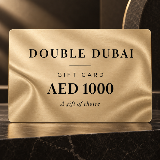 Double Dubai E-Gift Card: gold gift card, AED 1000, on a dark marble surface